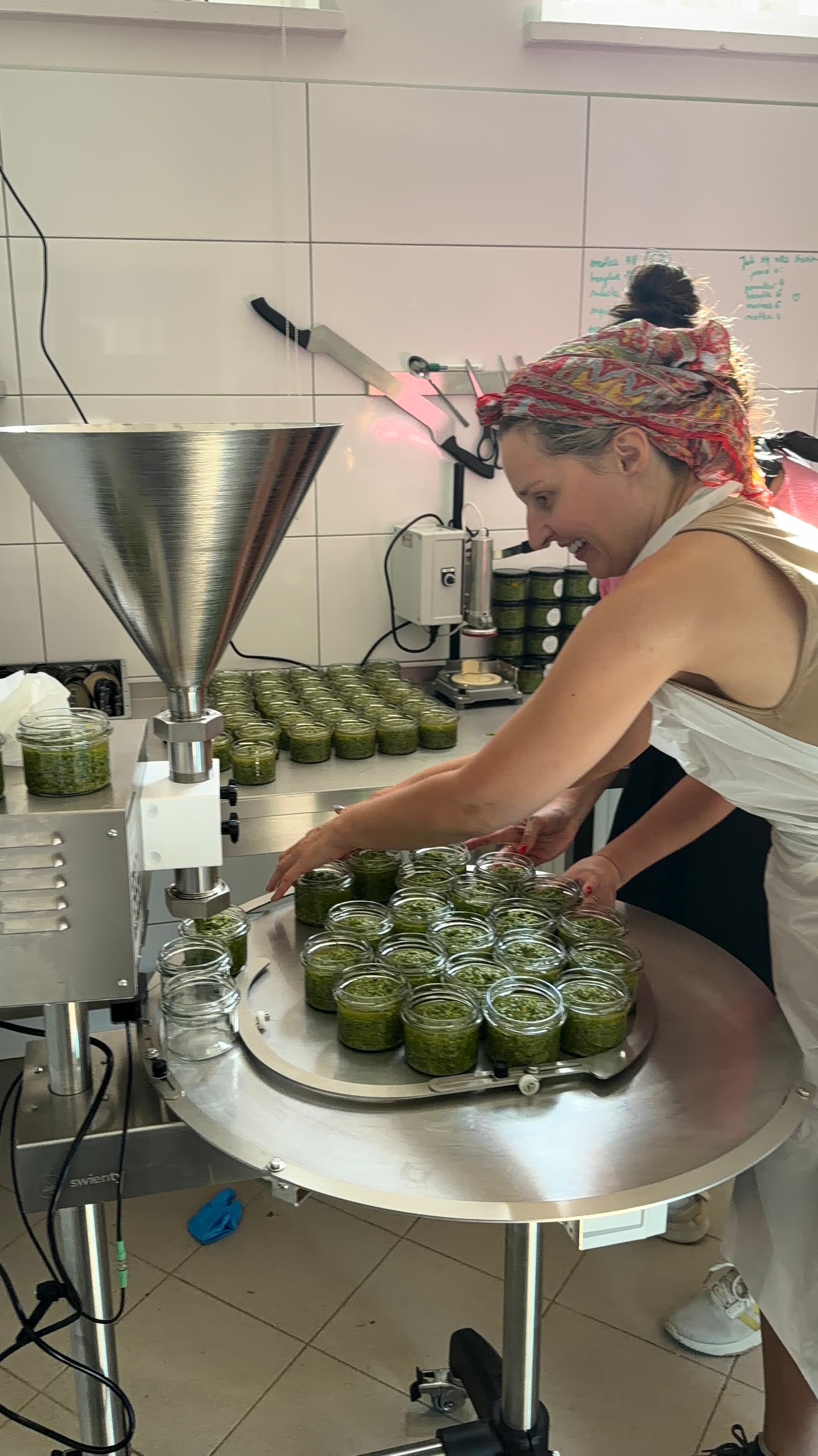 Ręczne napełnianie słoików pesto w pracowni